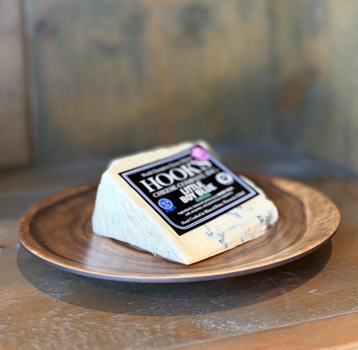 Wedge of Wisconsin sheep's milk Little Boy Blue cheese on slate